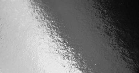 Silver foil texture background with uneven surfaceの写真素材
