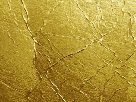 Grunge gold foil texture background with cracks and scratchesの写真素材