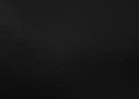 Black foil texture background with uneven surfaceの写真素材