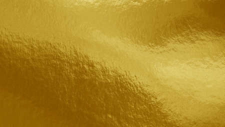 Gold foil background with highlights and uneven textureの写真素材