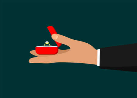 Man's hand holdind a red jewelry box with an engagement ring. Making a marriage proposal. Wedding...