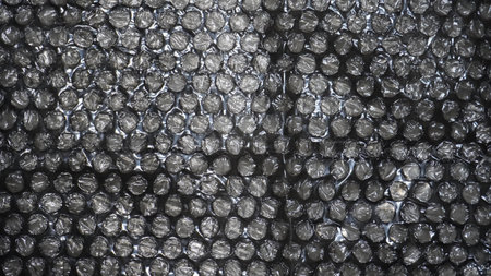 Detailed view of black bubble wrap, a protective material used for packaging and shipping delicate...
