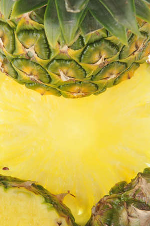 Round parts of pineapple as yellow backgroundの写真素材