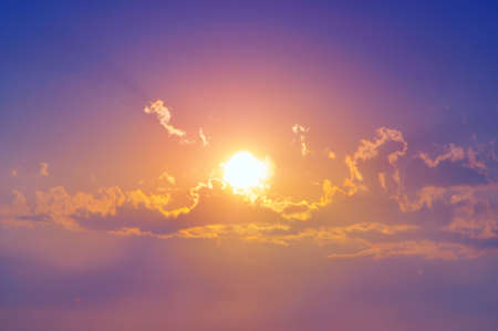 A sunburst shining through the clouds.