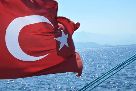 Turkish flag fluttering on a boat, Mediterranean, Antalia, Turkeyの写真素材