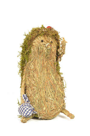 handmade hedgehog of hay and moss, isolated on white backgroundの写真素材