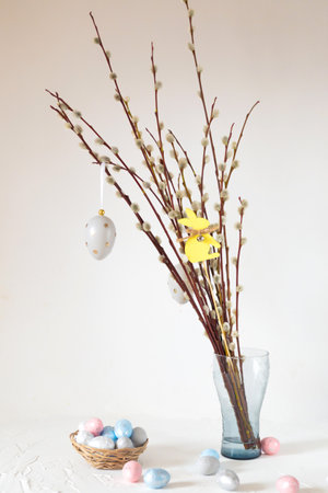 Spring crochet and knitting. Beautiful Easter still life with a bouquet of willow twigs decorated...