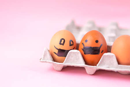 eggs decorated in a box, eggs in a mask, eggs in a pandemicの写真素材