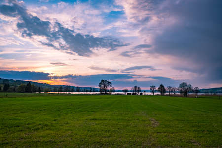 Sunset over meadow fieldの写真素材