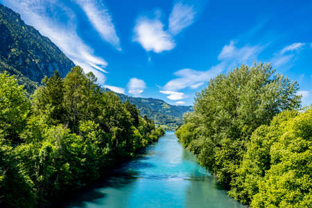 River and mountains with blue sky - Interlaken, Switzerlandの写真素材