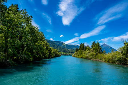 River and mountains with blue sky - Interlaken, Switzerlandの写真素材