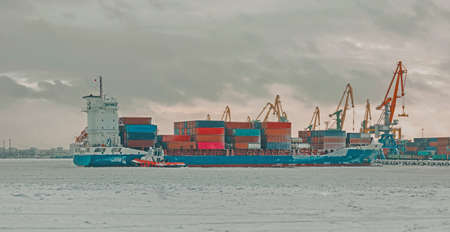 A cargo ship in the port of St. Petersburg in winterの写真素材