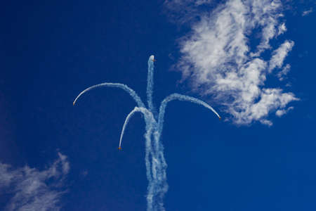 Inversion trail of the plane. A small plane practices aerobaticsの写真素材