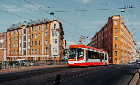 Modern city tram crossing bridge in St. Petersburg. Public transportation concept. City background, banner.の写真素材