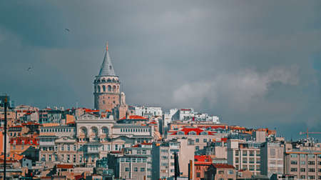 View of Istanbul Houses with Galata Tower under dramatic skyの写真素材