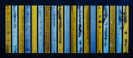 Yellow and white lines of pedestrian crossing on the dark asphalt road.の写真素材