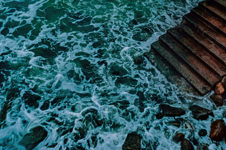Concrete stairways goes down into the sea . Stairs that go down to the water.の写真素材