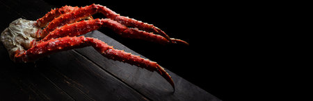 Fresh red king crab crab claws on vintage wooden background. Tasty kamchatka crabs claw. Top View with Copy space.の写真素材