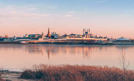 The Kazan Kremlin at sunset in winter. Reflection in the ice of a frozen river. Beautiful view of the cityの写真素材