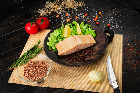 Cold Smoked oily fish fillet. Seafood in a wooden bowl on a napkin. Top view.の写真素材