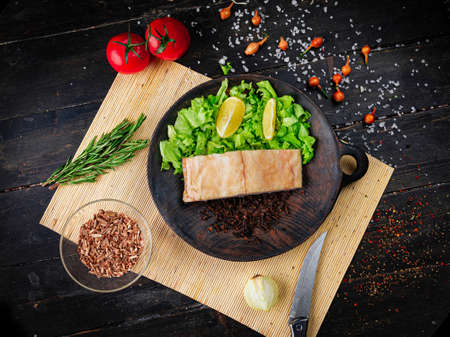 Cold Smoked oily fish fillet. Seafood in a wooden bowl on a napkin. Top view.の写真素材