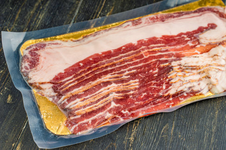 Raw smoked beef bacon in plastic pack.の写真素材