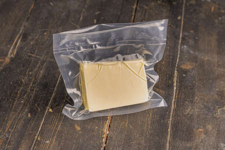 Fresh butter in a vacuum packet. Top view.の写真素材
