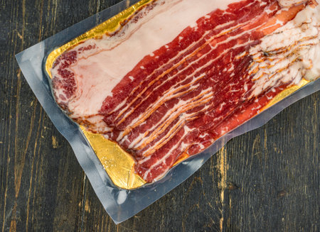 Raw smoked beef bacon in plastic pack.の写真素材