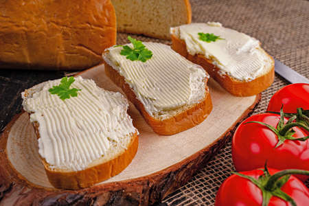 Tasty bread with butter on kitchen table.の写真素材