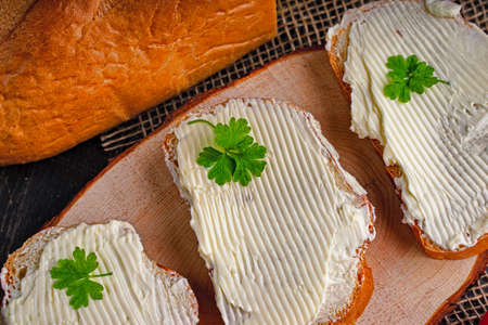 Tasty bread with butter on kitchen table.の写真素材