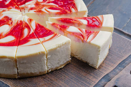 New York Style Cheesecake with Strawberries on a cutting boardの写真素材
