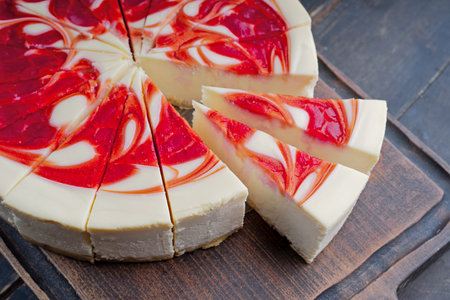 New York Style Cheesecake with Strawberries on a cutting boardの写真素材