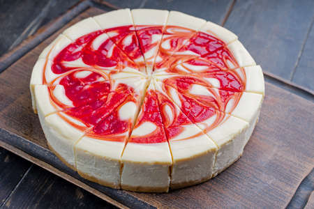New York Style Cheesecake with Strawberries on a cutting boardの写真素材