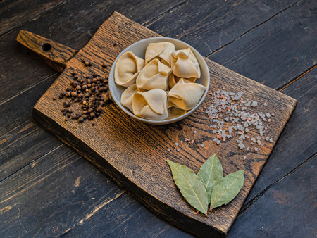 Frozen russian crude pelmen or dumplings in a white bowlの写真素材