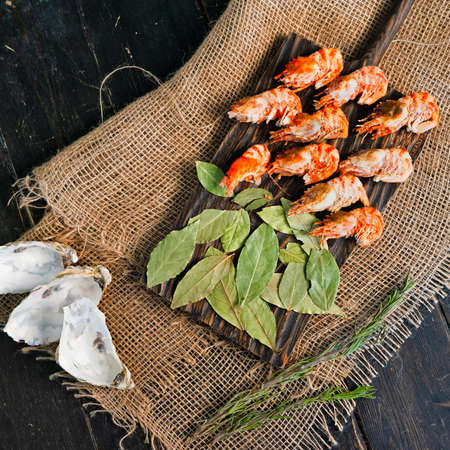 Greenland prawns on a wooden cutting boardの写真素材