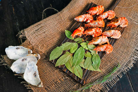 Greenland prawns on a wooden cutting boardの写真素材