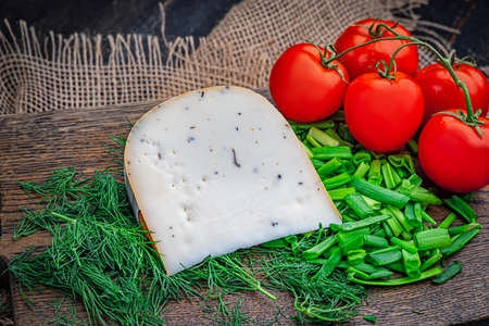 A piece of delicious goats milk cheese with prunesの写真素材