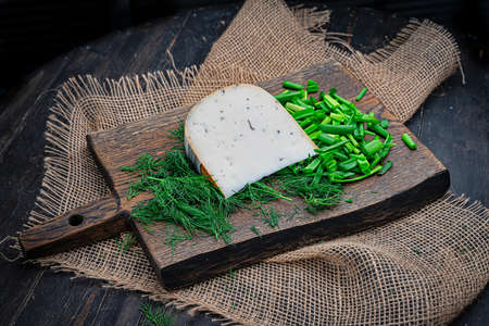 A piece of delicious goats milk cheese with prunesの写真素材