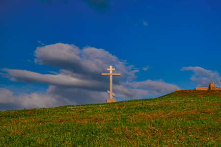 Wooden orthodox cross on a hill in the sunsetの写真素材