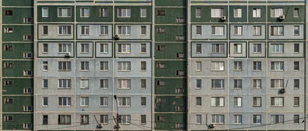 Windows and balconies of the residential building. Old urban obsolete facade of panel house.の写真素材