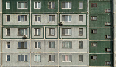 Windows and balconies of the residential building. Old urban obsolete facade of panel house.の写真素材