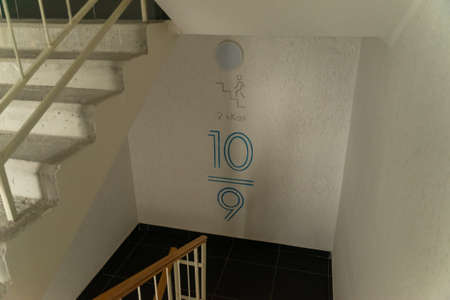 Stairwell in an apartment building. Going down the stairs. Loss of calories during the descent.の写真素材