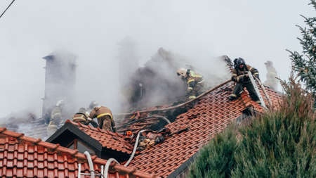 Firefighters are fighting a fire on the roof of a mansion. Firefighter team work. Attacking a fire with water. Kazan, Russia. 02 November 2021.のeditorial素材