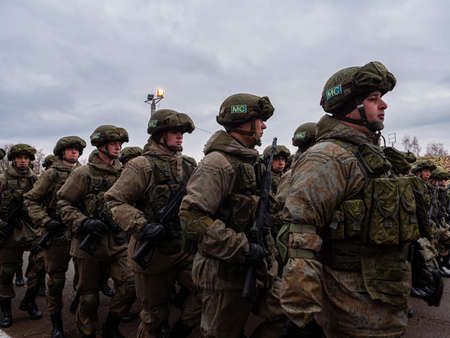 Kazan, Russia. 08 November 2021. Special forces soldiers with rifle in full gear. Camouflaged soldier marching in formation.のeditorial素材