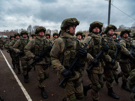 Kazan, Russia. 08 November 2021. Special forces soldiers with rifle in full gear. Camouflaged soldier marching in formation.のeditorial素材