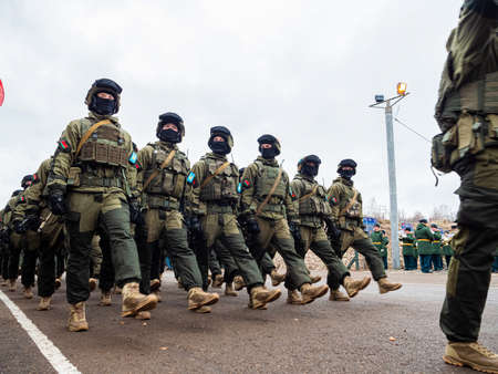 Kazan, Russia. 08 November 2021. Special forces soldiers with rifle in full gear. Camouflaged soldier marching in formation.のeditorial素材
