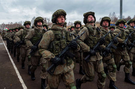 Kazan, Russia. 08 November 2021. Special forces soldiers with rifle in full gear. Camouflaged soldier marching in formation.のeditorial素材