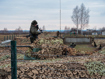 Kazan, Russia. 08 November 2021. A soldier examines the equipment covered with camouflage netting. Russian Army. Army exercises of Collective Security Treaty Organization countriesのeditorial素材
