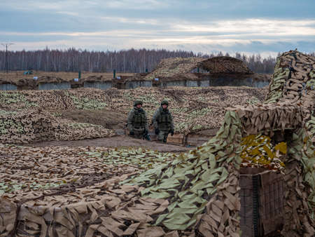 Kazan, Russia. 08 November 2021. Army exercises. Russian army soldiers among trenches covered with camouflage netting.のeditorial素材