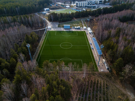 A football pitch in the middle of a forest. Aerial view. Drone view. Playing football in the countryside. .の写真素材
